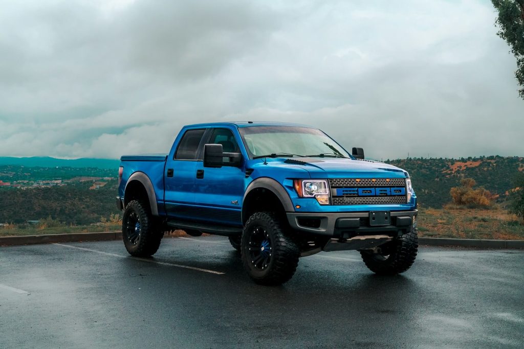 blue ford f-150 raptor pickup